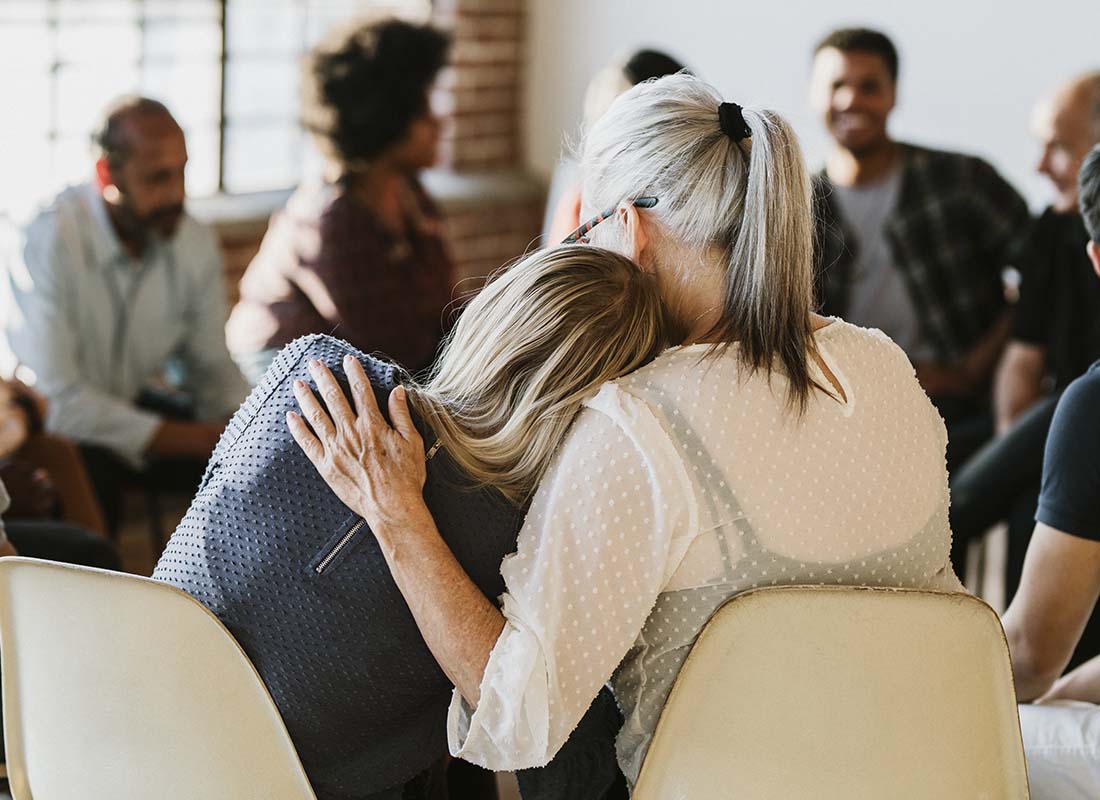 Residential Drug Treatment Insurance - People Supporting Each Other in a Rehab Session With Woman Laying Her Head on a Fellow Support Members Shoulder