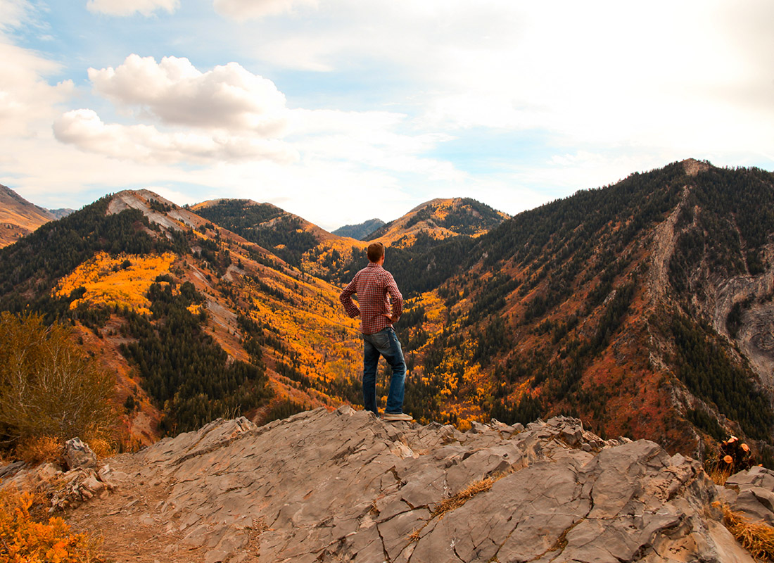 Service Center - Man Stands and Admires the Fall Colors in View of Mountains